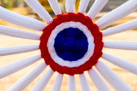 Colorful holy thread crochet pattern, a white string held by Buddhist priests while chanting or put around a house to keep off evil spiritsの写真素材