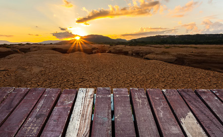 Wooden platform on cracked earth near drying water on twilight at at Sam Pan Bok in Mekong river. Ubonratchathani Province ,Thailandの写真素材