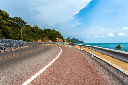 Beautiful bicycle road sign in the curve road near the ocean at Nern Nang Phaya viewpoint. Chanthaburi Province,Thailandの写真素材