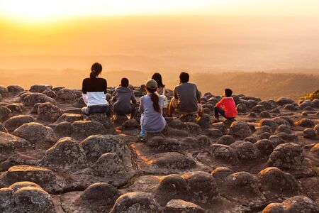 Silhouette of sunset and light flare at the mountain named Lan Hin Poom at Phu Hin Rong Kla National Park, Phitsanulok Province, Thailandの写真素材