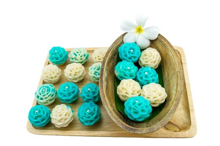 Traditional Thai dessert flower shape stuff with crush soybean and taro (Thai name kanom Chor phaka) in wooden basket on fabric sisal isolated on white background.の写真素材