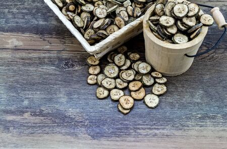 raw organic green bananas sliced spread to dry from soft sun bath on wooden  basket.の写真素材