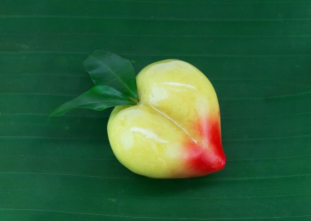 peach lookchoob thai dessert on banana leafの写真素材