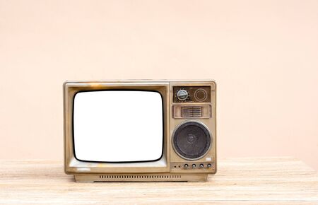 Retro old TV cut out screen on wooden table with wall background.の写真素材