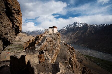 A precariously positioned building overlooks the Himalayan valley below.の写真素材