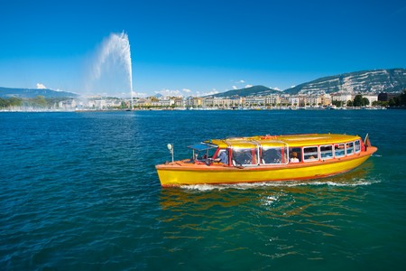 A water taxi plies the pristine waters of Lake Geneva.の写真素材