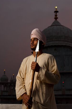 PAONTA SAHIB - MAY 22: A young Sikh man brandishing a spear at the Paonta Sahib Gurudwara, famous for its past warriors May 22, 2009 in Paonta Sahib, Himachal Pradesh, Indiaのeditorial素材