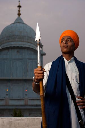 PAONTA SAHIB - MAY 22: A young Sikh man brandishing a spear at the Paonta Sahib Gurudwara, famous for its past warriors May 22, 2009 in Paonta Sahib, Himachal Pradesh, India