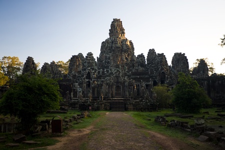 The tip of the Bayon temple is illuminated by the rising sun at the Angkor Wat Temple complex in Siem Reap, Cambodia.の写真素材