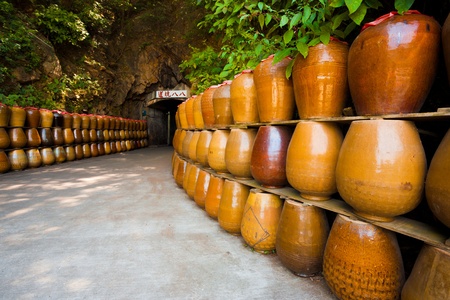 The entrance to an old military tunnel, Tunnel 88 now acts as a storage area for large jars which contain locally distilled alcohol and spirits.  It is now a major tourist attraction on Nangan Island of the Matsu archipelago in Taiwan.の写真素材