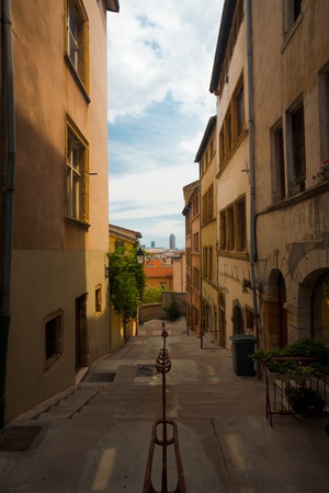 A group of traditional homes in a narrow alleyway leading to downtown in the Fourviere Hill neighborhood of Lyonの写真素材