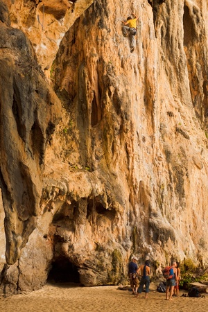 Railay Beach, Thailand - January 31, 2011: A male climber scales the face of a limestone cliff in Railay beach, a hub of rock climbing activities in Thailand January 31, 2011 at Phra Nang Railay Beach, Thailand.のeditorial素材