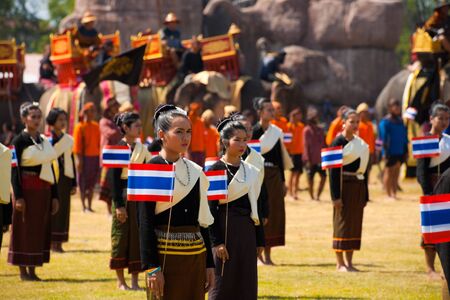 SURIN, ISAN, THAILAND - NOVEMBER 20, 2010: Female Thai dancers carry flags during a performance at the annual Surin Elephant Roundup on November 20, 2010 in Surin, Thailandのeditorial素材