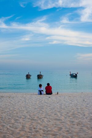 KO LIPE, THAILAND - JANUARY 24, 2010: A couple shares a quiet moment on the beach on January 24, 2010 in Ko Lipe, Thailand. Ko Lipe has shot to fame after being in National Geographic Best Trips 2012のeditorial素材