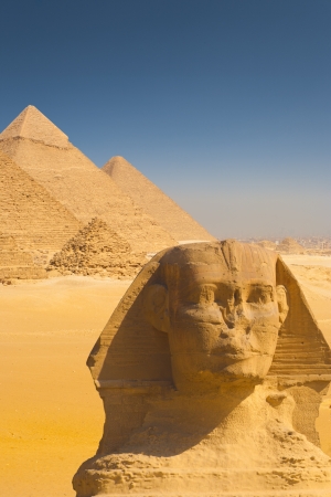 A beautiful composite of the Giza pyramids behind a closeup of the head of the great Sphinx in Cairo, Egyptの写真素材
