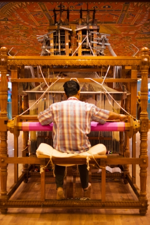 TIRUNELVELI, INDIA - DECEMBER 9, 2009: An unidentified Indian man makes a traditional sari to demonstrate a handloom on December 9, 2009 in Tirunelveli, Indiaのeditorial素材
