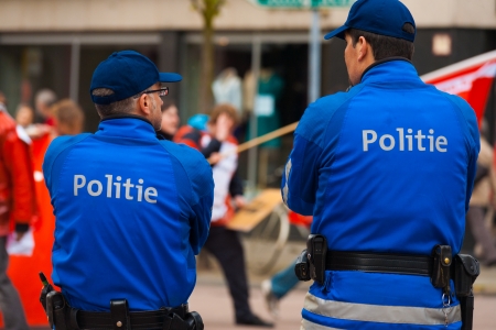 ANTWERP, BELGIUM - MAY 1, 2010: Two Flemish Policemen watch over marchers and keep the peace at the annual May Day Parade on May 1, 2010 in Antwerp, Belgiumのeditorial素材