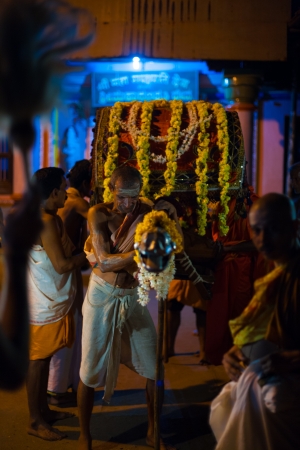 GOKARNA, INDIA - MARCH 26, 2009: Unidentified Indian brahmins pull a highly decorated palanquin at night during a monthly full moon hindu ceremony on March 26, 2009 in Gokarna, Indiaのeditorial素材