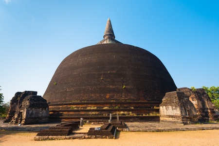 The rear of the Rankoth Vehera, the largest Buddhist stupa at the ruins of the ancient kingdom capitol of Polonnaruwa, Sri Lankaの写真素材