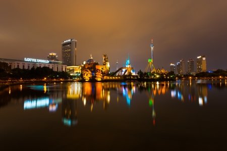 SEOUL, KOREA - AUGUST 26, 2009: The lights of Lotte World, a Korean amusement park and major tourist destination, reflect from the surface of a lake at night in Seoul, South Korea on August 26, 2009のeditorial素材