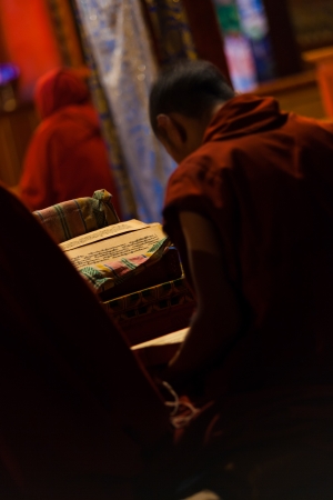 BOMI, CHINA - OCTOBER 15, 2007: An unidentified Tibetan boy studies buddhist texts in a monastery to be a monk, a waning tradition among young Tibetan boys in Tibet on October 15, 2007 in Bomi, Chinaのeditorial素材