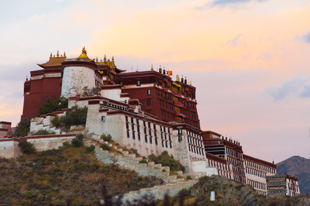 Darkness approaches at the gloomy evening Potala Palace as the sunset fades in the sky in Lhasa,...