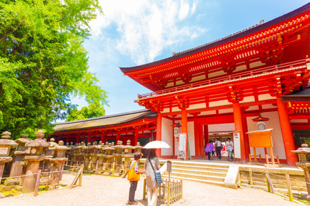 NARA, JAPAN - JUNE 24, 2015: Japanese people at front red gate entrance to Kasuga-Taisha Shinto Shrine at the Todai-ji temple complex on a blue sky day. Horizontalのeditorial素材