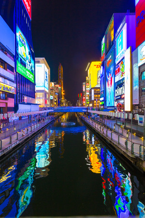 OSAKA, JAPAN - JUNE 23, 2015: Bright illuminated signs on banks of Dotonbori canal at night in Namba district of Osaka, Japan. Verticalのeditorial素材