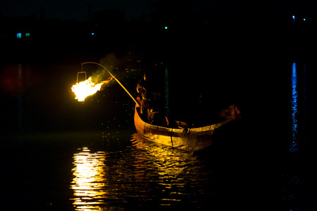 Inuyama, Japan - July 5, 2015: Night fire is used to help cormorant bird catch fish in a traditional form of Japanese fishing, ukai by firelight on Kiso River in Gifu Prefectureのeditorial素材