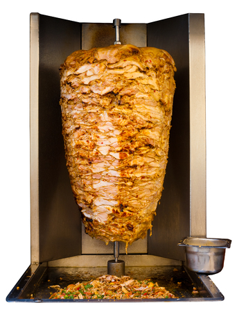 Grilled skewered chicken, a traditional meat served inside a shawarma sandwich in the Arab countries in Middle East, cooking in machine isolated on pure white backgroundの写真素材