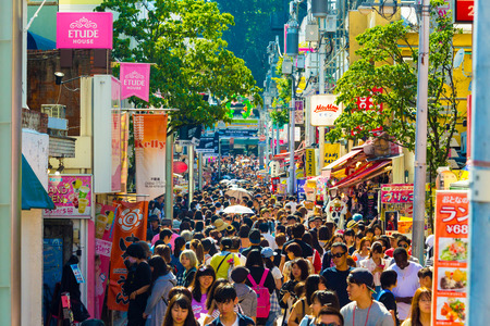 Tokyo, Japan - June 24, 2016: Many young people walking down crowded and bustling shopping street in consumerism mecca lined with stores on busy Takeshita Doriのeditorial素材