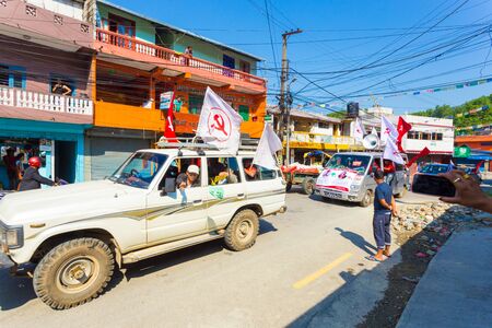 Pokhara, Nepal - May 11, 2017: Communist Party supporters waving Maoist flags and campaigning for the 2017 national electionsのeditorial素材