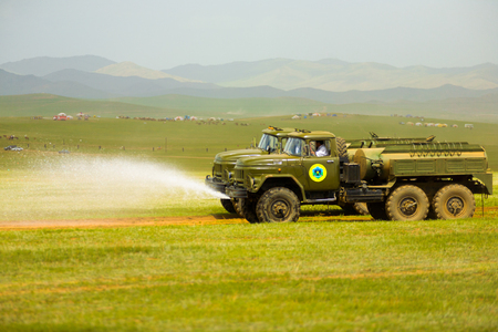 Ulaanbaatar, Mongolia - June 12, 2007: Trucks spraying water down on the course in preparation of the start of the horse racing competition at the Naadam Festivalのeditorial素材