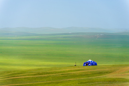 A lone purple yurt stands in the vast Mongolian steppe in rural Mongoliaの写真素材