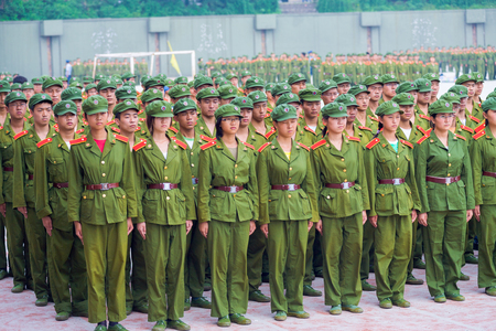 Changsha, China - September 5, 2007: Male and female Chinese university students in green uniforms line up in formation for compulsory military trainingのeditorial素材