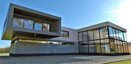 Gray brick decor plus concrete wall. Contemporary design house under the blue sky. 3d rendering....