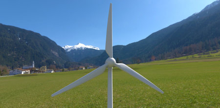 The blades of an industrial wind turbine against the backdrop of a mountain village. Renewable energy plus self-contained power supply. 3d rendering.の写真素材