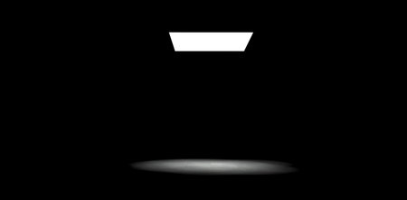 Invisible light enters a dark room through an imaginary ceiling, leaving a half-light spot on the concrete floor. 3d rendering.の写真素材