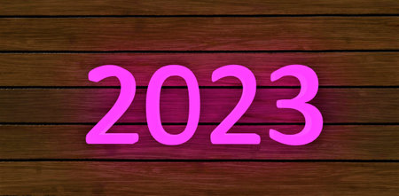 The number 2023 written in pink luminescent colors on a plate from the facade board. Can be used in Christmas theme. 3d rendering.の写真素材