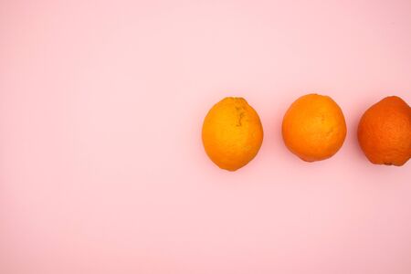 Oranges on pink background