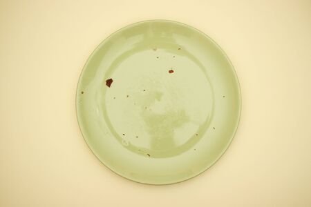 Empty green dish on yellow backgroundの写真素材