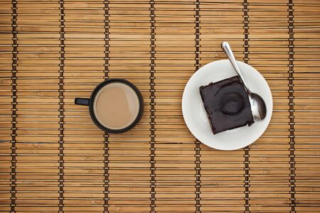 Cup of coffee and chocolate cake on the tableの写真素材