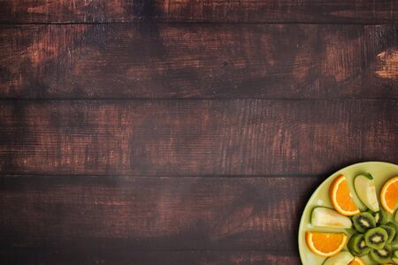 Green plate with fresh fruit salad