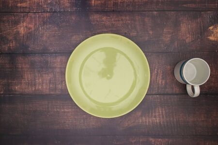 Empty green plate and cup on the tableの写真素材