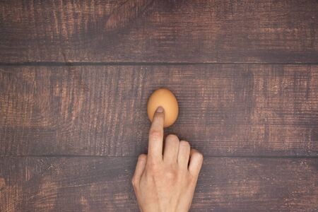 Woman's finger on the boiled eggの写真素材