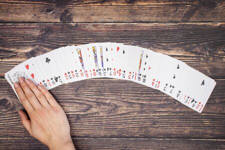 Woman's hand on the deck of cardsの写真素材