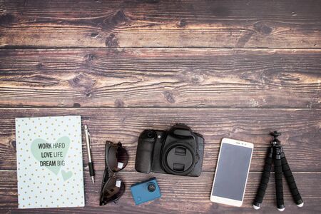 Travel kit and cameras on wooden backgroundの写真素材