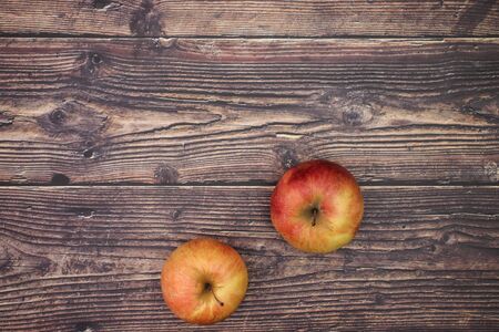 Beautiful red and fresh apples on the wooden table