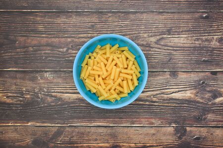 Fresh pasta in blue dish on the tableの写真素材