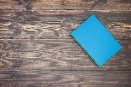 One blue book on wooden tableの写真素材
